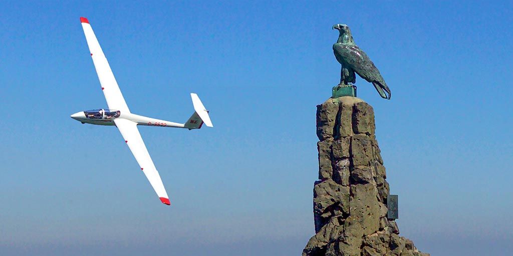 Glider above the aviators' memorial on the Wasserkuppe